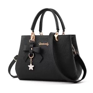 PU leather womens handbag with bow and star pendants can be carried by hand over the shoulder or crossbody large-capacity commuter bag simple and versatile for everyday use