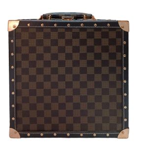 Brown checkered makeup bag with brass corner protectors and handle.