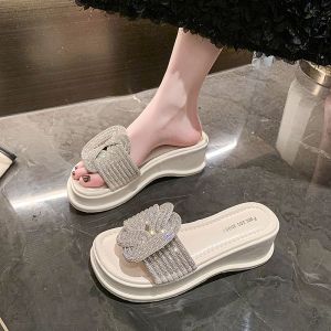 Internet Celebrity Fashion: Rhinestone Sandals & Women's Summer Flats\\n\\n What Are Rhinestone Sandals?\\n\\nRhinestone sandals are a popular style of women's summer flats that feature dazzling rhinestones embedded in the upper material. These fashionable sandals come in various styles, making them suitable for young people aged 18-40 years old. The upper material is made of PU, and the soles are rubber, providing a lightweight, non-slip experience.\\n\\n Key Features of Rhinestone Sandals\\n\\n* Upper material: PU\\n* Heel height: middle heel (3cm-5cm)\\n* Sole material: rubber\\n* Style: Korean version\\n* Production process: gluing\\n* Insole material: PU\\n* Heel bottom style: muffin base\\n* Function: lightweight, non-slip, heightened\\n* Pattern: solid color\\n* Popular elements: rhinestones, platforms\\n\\n Who Can Wear Rhinestone Sandals?\\n\\nRhinestone sandals are perfect for young women aged 18-40 years old who enjoy wearing stylish and comfortable footwear during summer days. These sandals are suitable for various occasions, including daily wear and beach outings.\\n\\n How to Choose the Right Rhinestone Sandals\\n\\nWhen selecting rhinestone sandals, consider the following factors:\\n\\n* Comfort: Ensure the sandals have a comfortable fit and provide adequate support.\\n* Durability: Look for sandals made from high-quality materials that will last longer.\\n* Style: Choose a style that complements your personal taste and fashion sense.\\n\\n Popular Styles of Rhinestone Sandals\\n\\n* Platform rhinestone sandals\\n* Glitter rhinestone sandals\\n* Open-toe rhinestone sandals\\n\\n How to Care for Your Rhinestone Sandals\\n\\nTo keep your rhinestone sandals looking their best, follow these cleaning and maintenance tips:\\n\\n* Clean the sandals regularly with a soft cloth and mild soap.\\n* Avoid exposing the sandals to excessive moisture or direct sunlight.\\n* Store the sandals in a cool, dry place.\\n\\n Storing Your Rhinestone Sandals\\n\\nStore your rhinestone sandals in a cool, dry place away from direct sunlight and moisture. Consider using a shoe bag or box to protect them from dust and damage.\\n\\n Where to Find Rhinestone Sandals\\n\\nRhinestone sandals are available at various online retailers and local stores/boutiques. Popular online retailers include Amazon, Zappos, and Nordstrom. Local stores/boutiques may carry a limited selection of rhinestone sandals.\\n\\n How to Pair Rhinestone Sandals with Your Outfit\\n\\nRhinestone sandals can be paired with various outfits to create different looks:\\n\\n* Everyday looks: Pair rhinestone sandals with casual dresses, shorts, or skirts for a chic and comfortable outfit.\\n* Beach & vacation outfits: Wear rhinestone sandals with swimsuits, cover-ups, or light dresses for a stylish and relaxed beach look.\\n\\n Conclusion\\n\\nRhinestone sandals are a popular style of women's summer flats that offer a unique blend of fashion and comfort. By considering factors such as comfort, durability, and style, you can choose the perfect pair of rhinestone sandals to complement your personal taste and fashion sense. Remember to care for your rhinestone sandals properly to ensure they last longer and maintain their appearance. With the right outfit pairing, rhinestone sandals can elevate any summer look.\n}