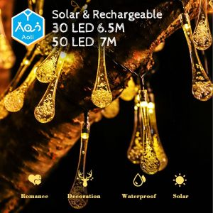 Aoli Solar Christmas Lights Outdoor - 30/50/100 Bulb 12M LED Warm Lights - Waterproof Garden String Lights - High Quality and Adjustable Solar Panel - Rechargeable Battery - Automatic Lighting for 8-10 Hours