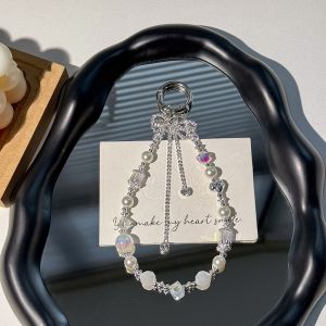 LITUILI MALL  ป้องกันการสูญหาย สายโซ่โทรศัพท์แบบโบว์ หัวใจ ห้อย สายคล้องโทรศัพท์มือถือ ตกแต่งกระเป๋า ลัทธิหรูหราเบา จี้โทรศัพท์สำหรับเด็กผู้หญิง ผู้หญิง ผู้หญิงสาว