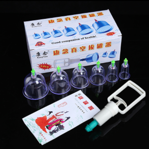 Traditional Cupping Therapy Tool For Full Body Massage And Tension Release With Ergonomic Hand Pump. Transparent cups with green valves ergonomic hand pump various sizes used for back massage.
