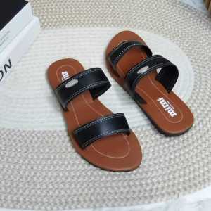 Brown black and beige flat sandals with two straps each.
