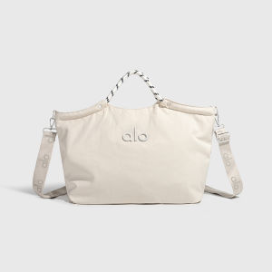Neutral Beige Small Alo Duffel Bag Contrast Brown Leather Trim Dual Side Bottle Pockets Multi Compartment Front Zipper Pocket Soft Water Resistant Nylon Lightweight Ladies Workout Shopping Handbag