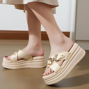 Black platform sandals with gold chain buckle detail. Thick sole open toe design slip-on style. Ideal for casual summer outings.