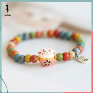 ส่วนลด 10 บาท สำหรับการซื้อ 1 ชิ้น สร้อยข้อมือแฟชั่นน่ารักเซรามิกรูปแมวนำโชคสำหรับเด็กผู้หญิงกำไลลูกปัดหลากสีปรับได้จี้รูปแมวเครื่องประดับสร้อยข้อมือนำโชคน่ารัก