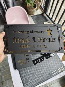 Laser cut acrylic memorial plaque with personalized names and dates decorative gold accents cross symbol and engraved message.