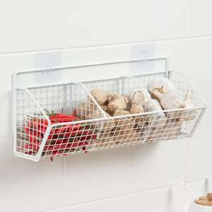 LUckylkh metal wall-mounted basket organizer with three compartments holding tomatoes garlic and ginger.