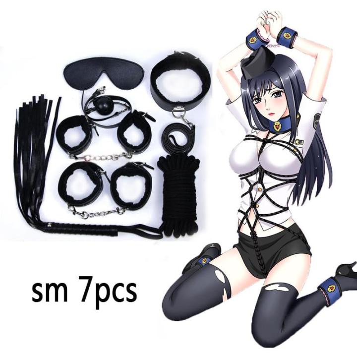 eros sex toys Torture of Andreev cross on the bedroom wall. VDSM equipment and sex toys.  Leather handcuffs with a chain on a gray sheet. The lashes hang in the room  for perversions. — Stock