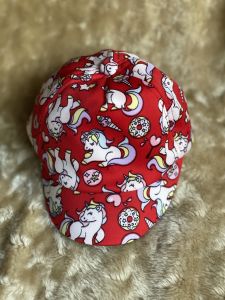 Cap with detachable shield for babies