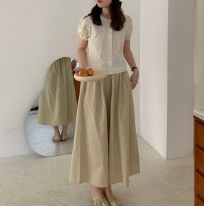 กระโปรงทรงเอเอวสูงผ้าฝ้ายทรงหลวมสไตล์เกาหลีสำหรับผู้หญิงในช่วงฤดูร้อนปี 2023 กระโปรงทรงเอสีพื้นยาวปานกลาง